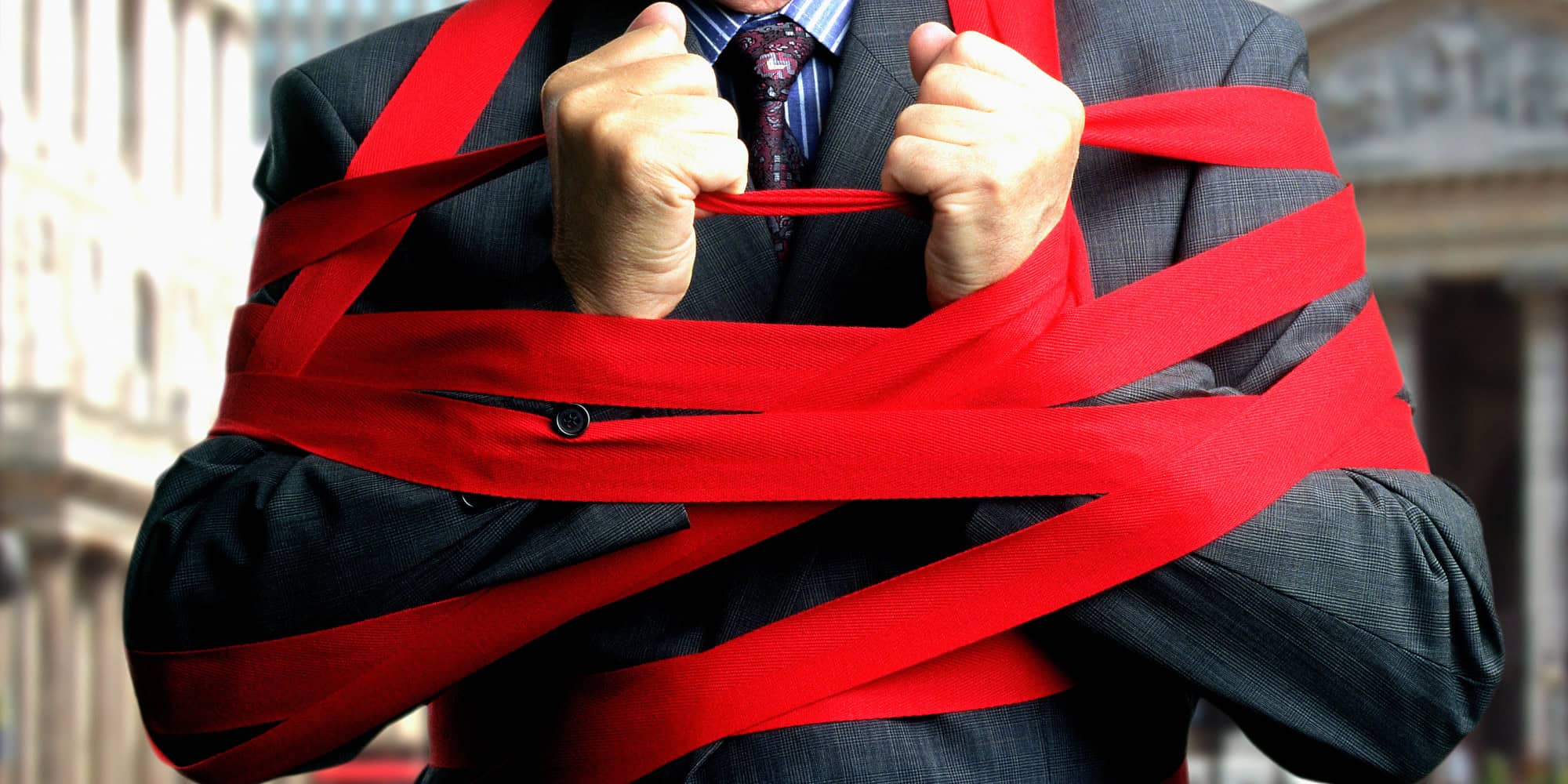 Image of Person tied up in red tape.